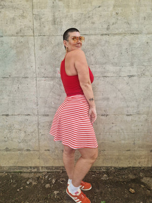 Popper Skirt Mini in Tomato Red on Bubblegum pink!  - Manners London