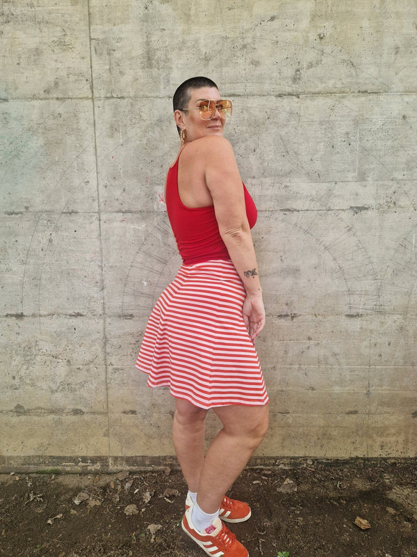 Popper Skirt Mini in Tomato Red on Bubblegum pink!  - Manners London