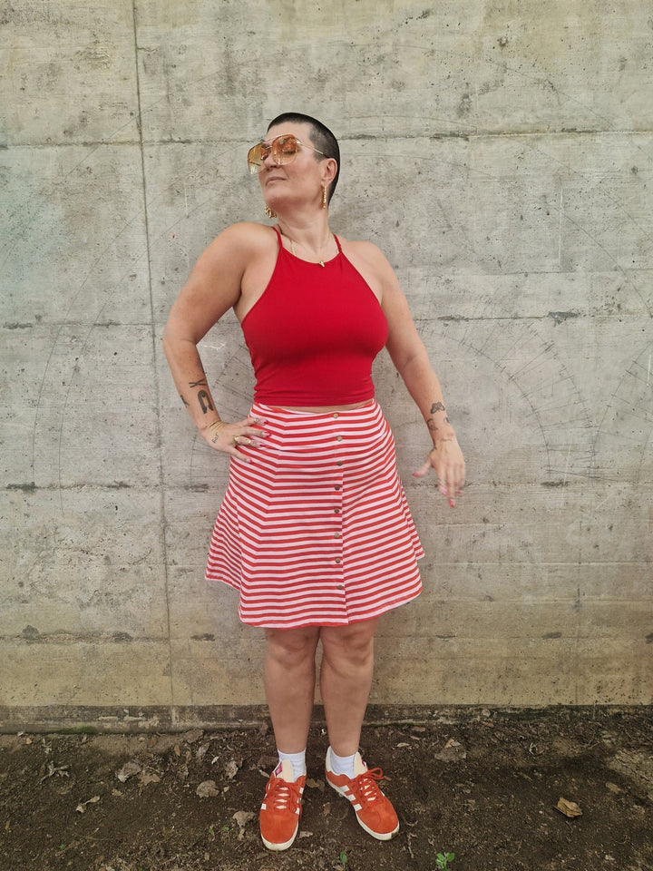 Popper Skirt Mini in Tomato Red on Bubblegum pink!  - Manners London