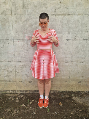 Popper Skirt Mini in Tomato Red on Bubblegum pink!  - Manners London