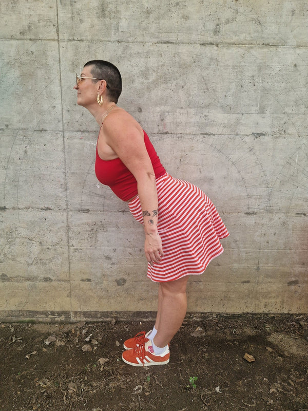 Popper Skirt Mini in Tomato Red on Bubblegum pink!  - Manners London