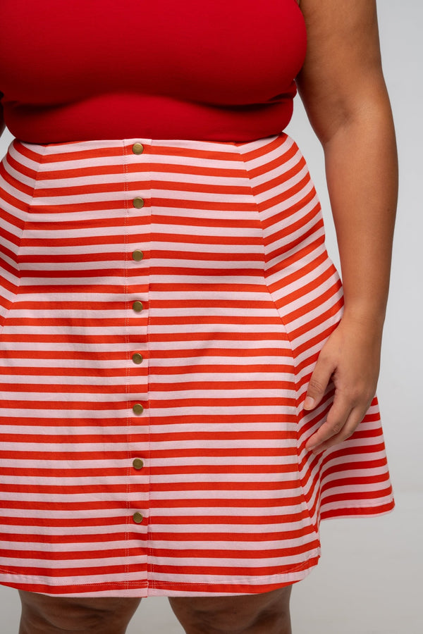 Popper Skirt Mini in Tomato Red on Bubblegum pink!  - Manners London